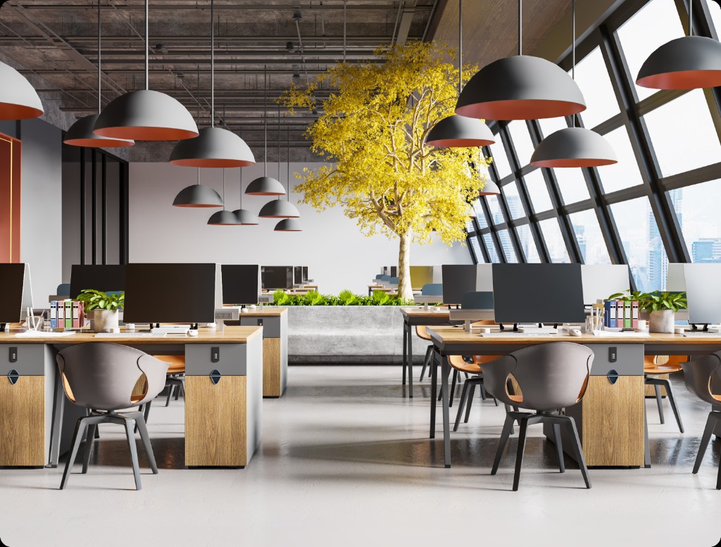 Open office with hanging dome lights, a yellow indoor tree, and wooden desks with grey chairs