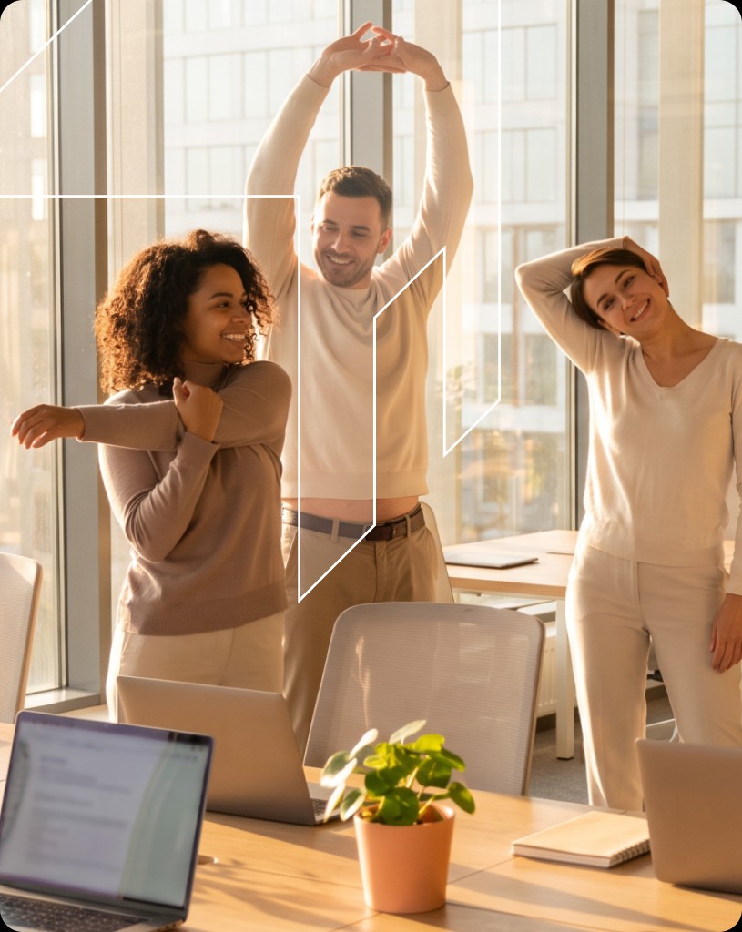 Three colleagues stretching together in a sunlit office