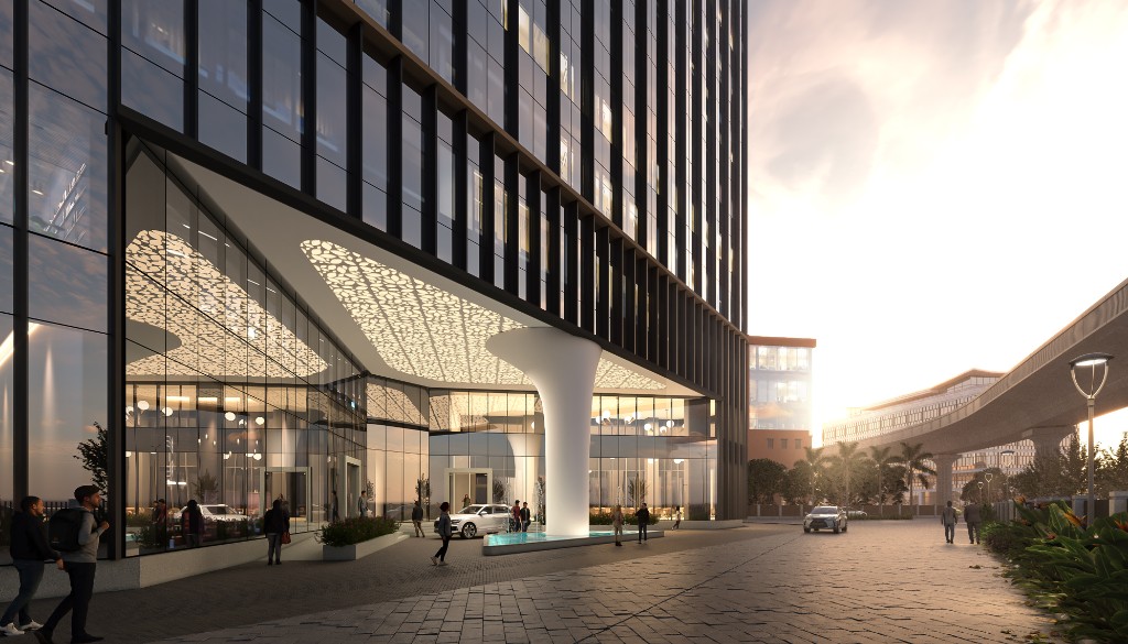Sunset view of a Casagrand commercial tower entrance with a sculpted canopy and glass facade
